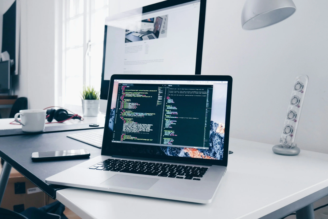 A laptop on a desk showing code
