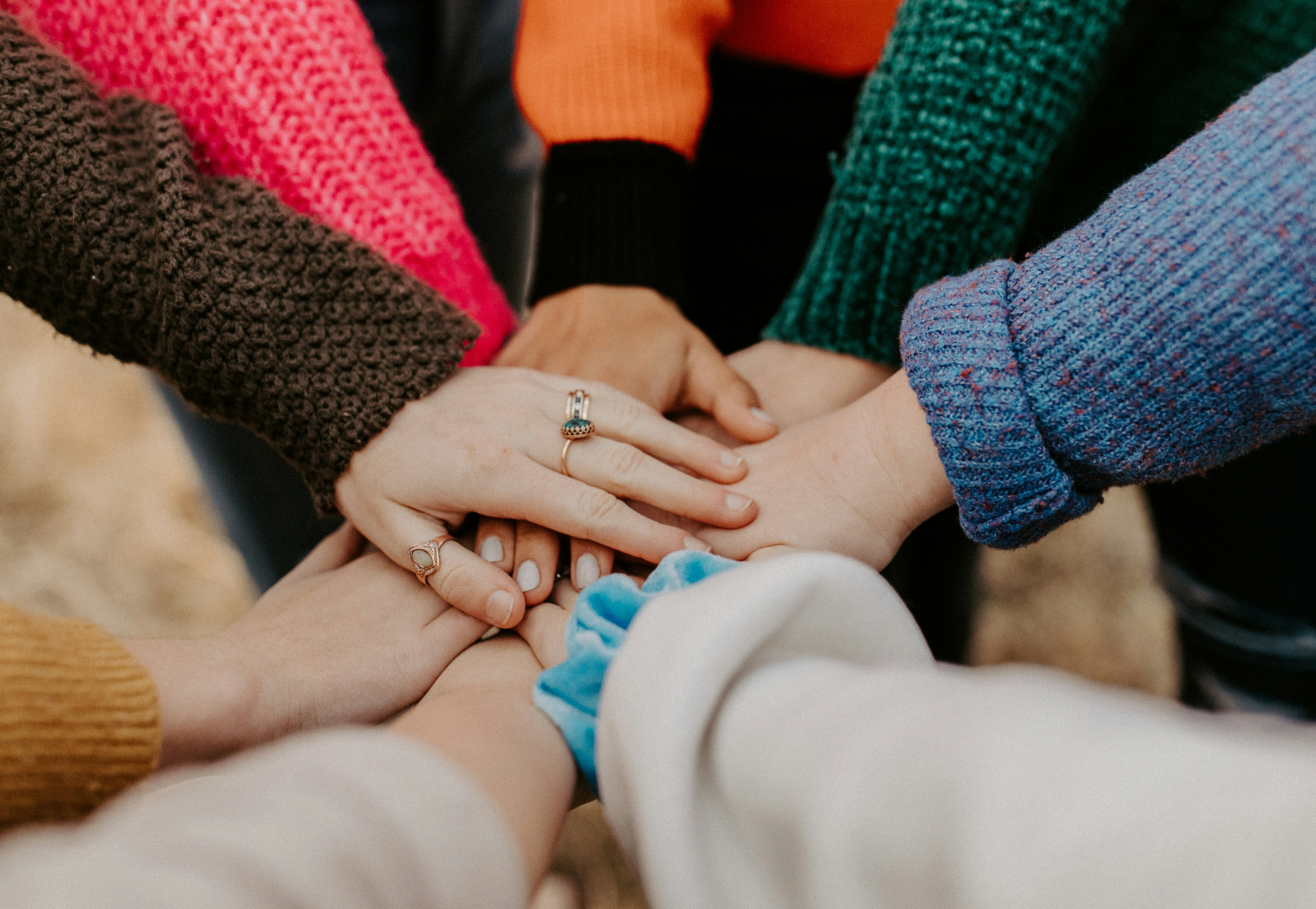 Non-profit team joining hands